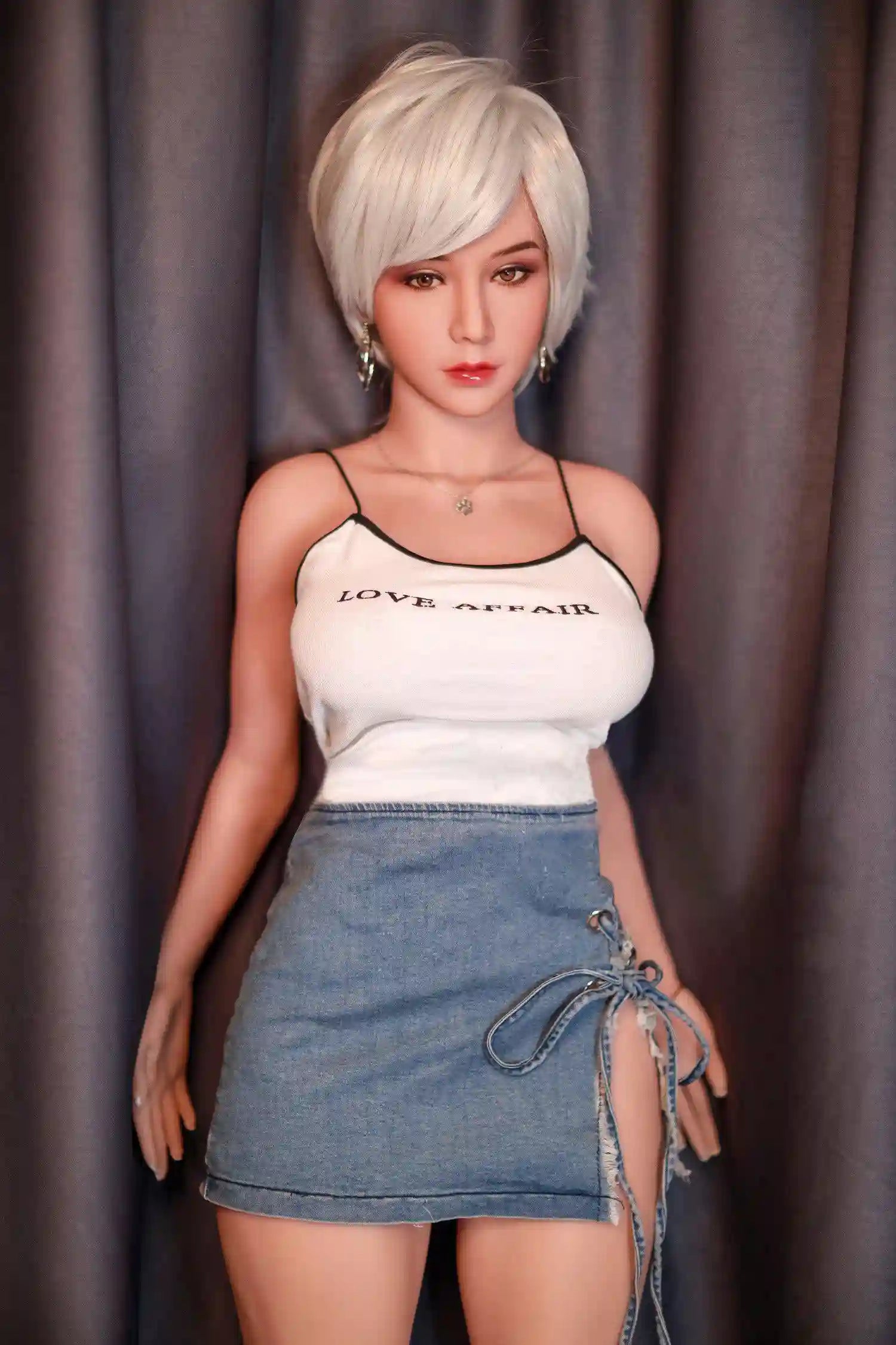Anahi short platinum blonde hair tan skin white fitted tank denim micro skirt bold Shibuya street style pose, standing in front of the hotel curtain – Asian blonde pornstar sex doll by TopLoveDoll
