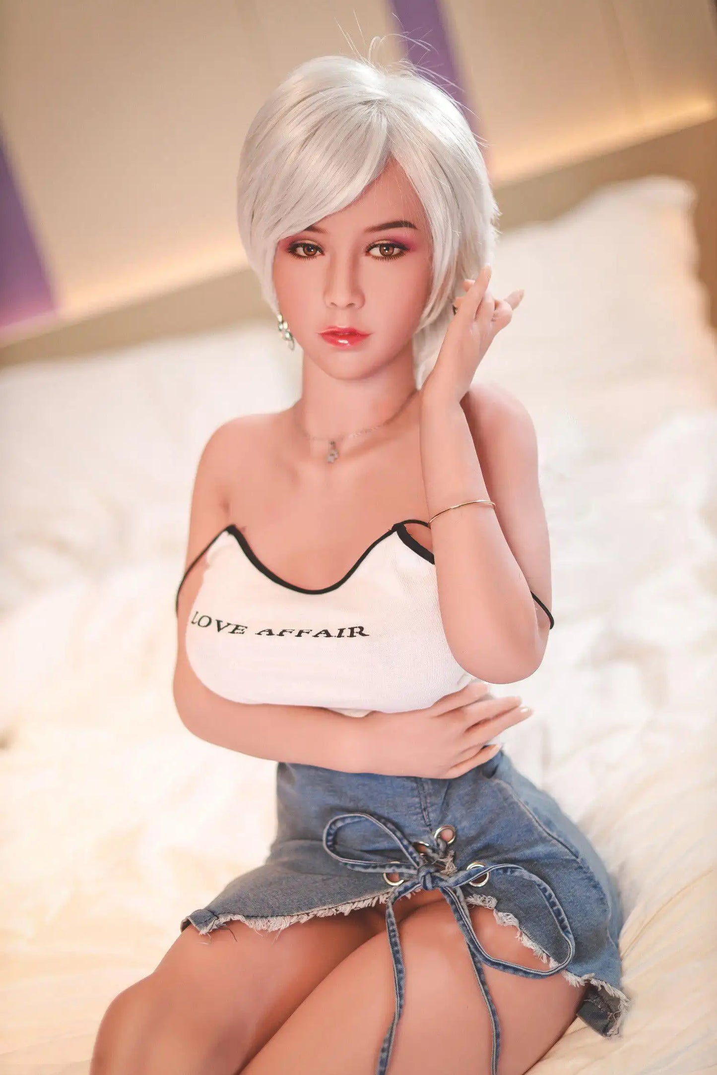 Anahi short platinum blonde hair tan skin white fitted tank denim micro skirt bold Shibuya street style pose, sitting on the hotel bed, bust shot – Asian blonde pornstar sex doll by TopLoveDoll