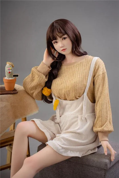 Astrid Asian bangs college sweetheart sex doll, sitting on the storage box chair, with her palm holding her head, looking into the camera- first love high school girl next door by TopLoveDoll