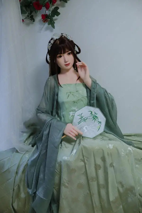 Autumn hanfu Asian girl next door sex doll, in green hanfu attire, ancient chinese hairstyle, sitting at the corner, under a branch of fake roses, traditional Chinese dress jade green beauty by TopLoveDoll