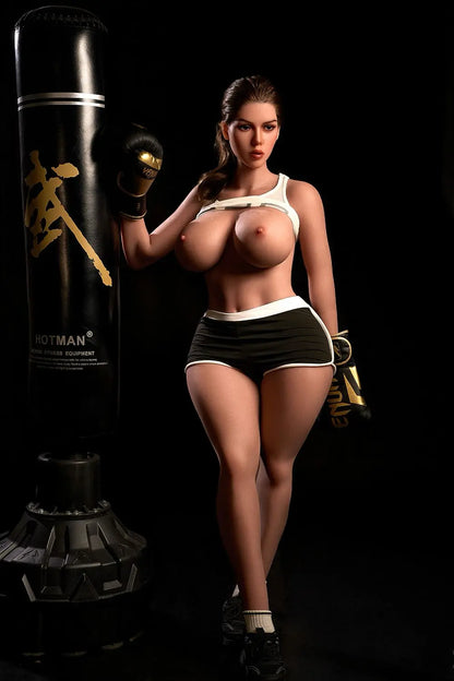 Sporty Nori latina sex doll kneeling in gym, white crop top, brunette hair, massive jiggly boobs, black shorts, lifelike BBW love doll by TopLoveDoll