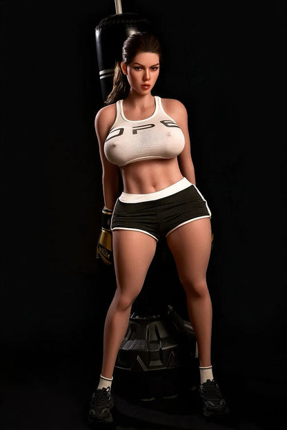 Sporty Nori realistic sex doll topless kneeling in gym, huge natural breasts, brunette hair, round hips, premium hispanic companion doll by TopLoveDoll