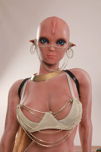 Front portrait of Vaelis showing large blue eyes, pointed ears, face chains and a silver top