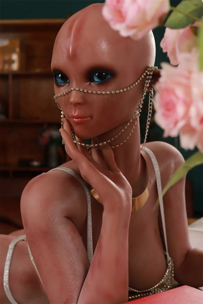 Close-up of Vaelis alien face framed by pink roses, showing blue eyes and decorative chains