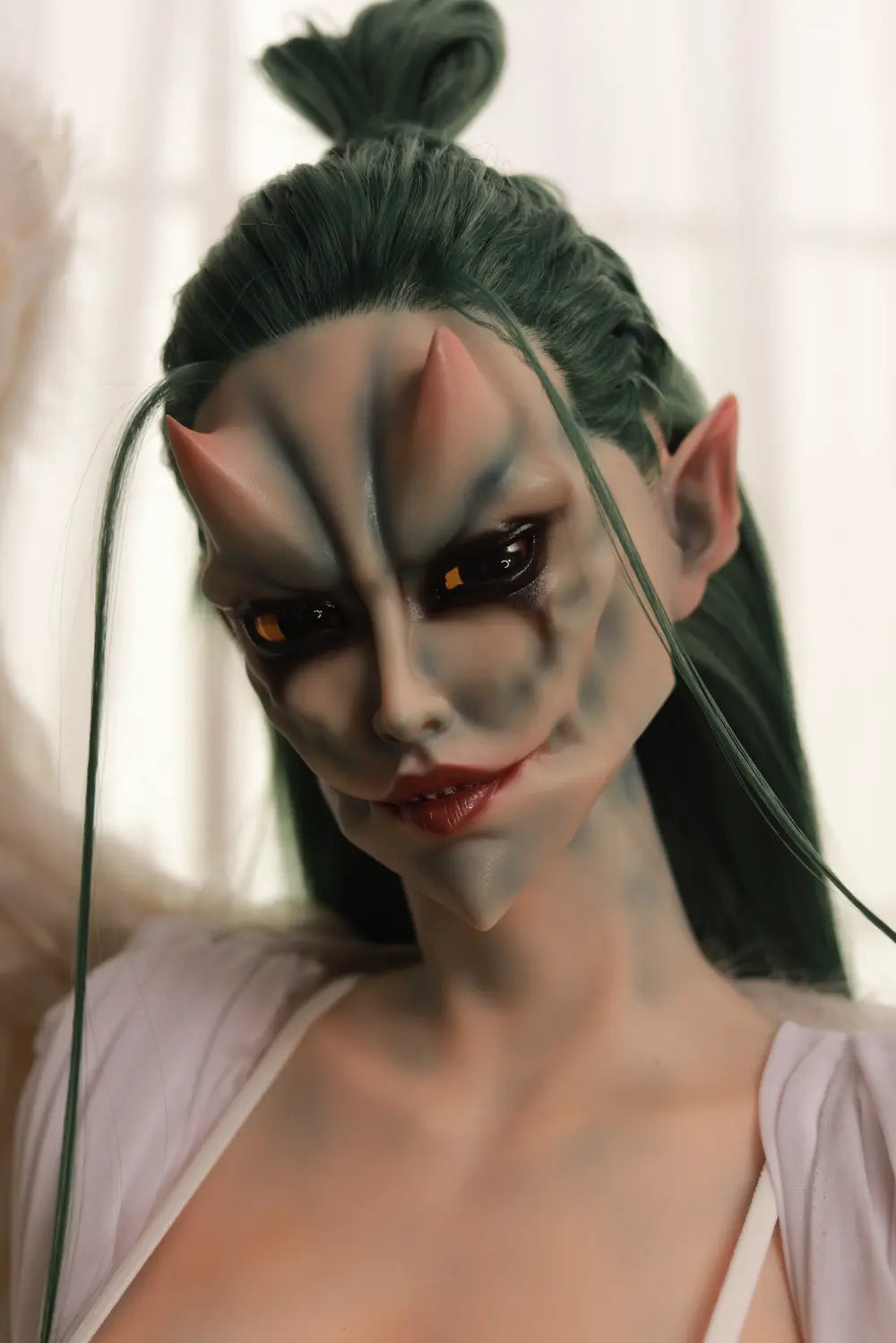 Closer portrait of Morveth sex doll showing dark eye surrounds and long green hair