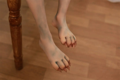 Close-up of Morveth sex doll's beast-like feet with claw-shaped toes above a wooden floor