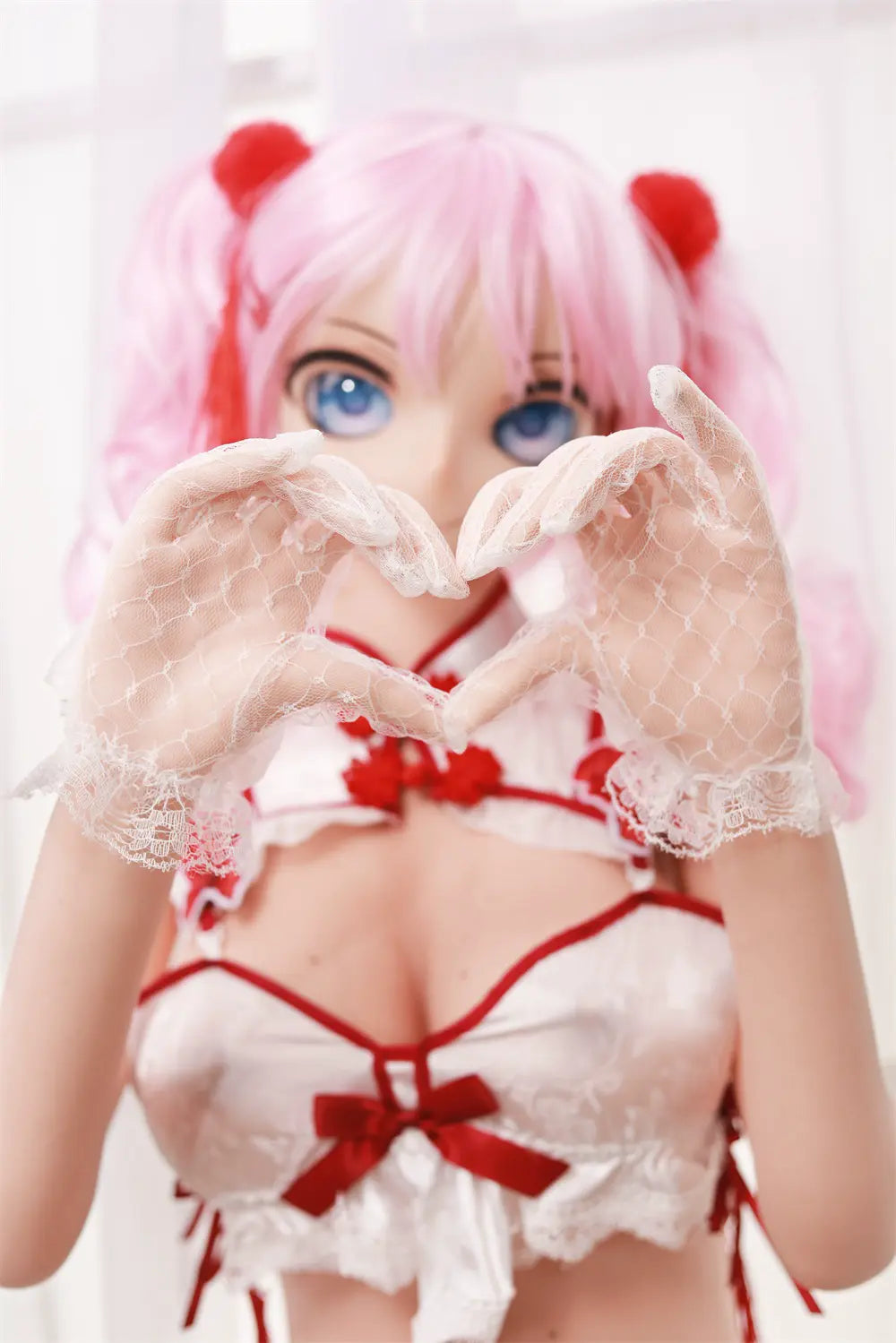Front portrait of Mirumi waifu sex doll with pink twin tails and red hair accessories