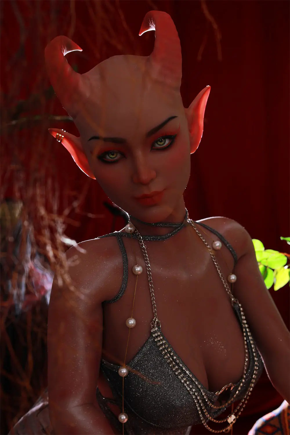 Close-up of Tauris sex doll showing curved horns, fin-shaped ears and decorative jewelry