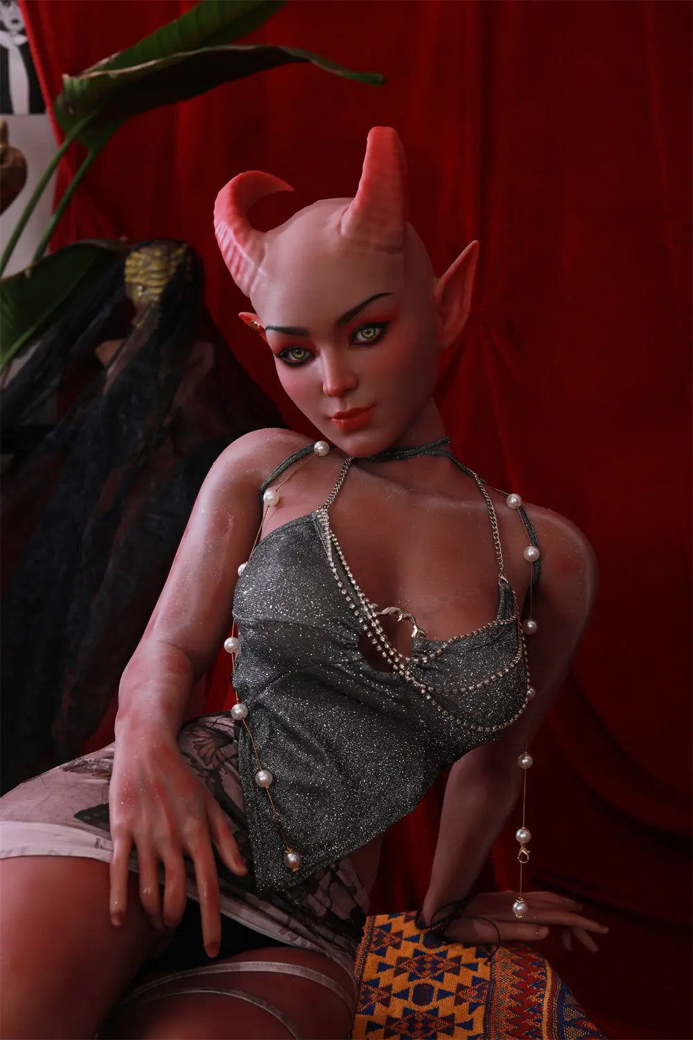 Close-up of Tauris sex doll's feet and lower legs resting on patterned fabric