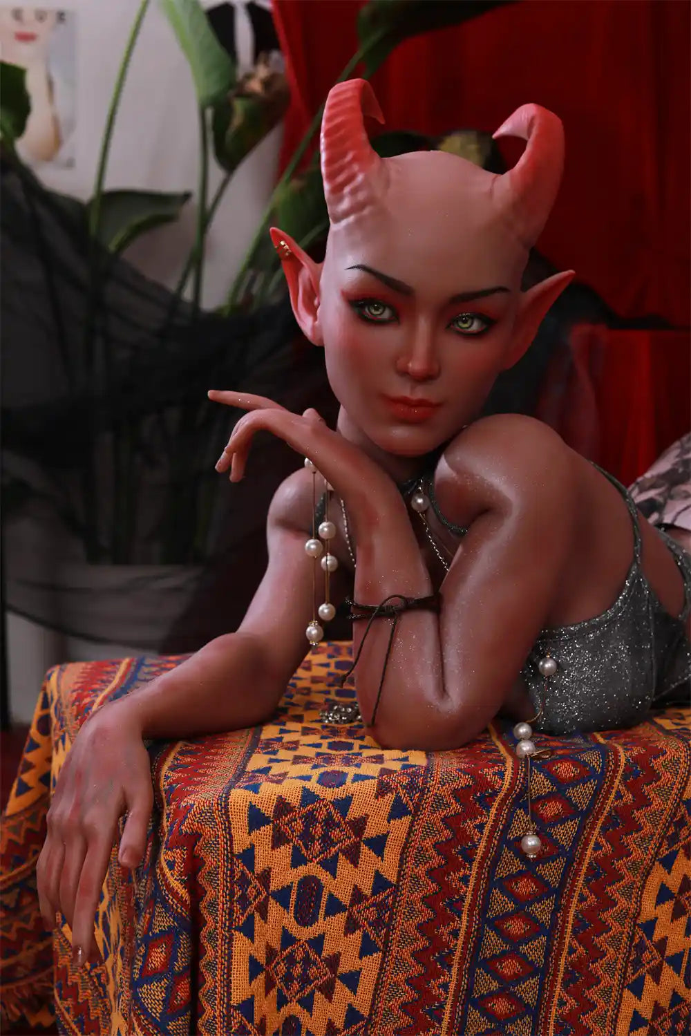 Front view of Tauris sex doll leaning forward with hands held near the face
