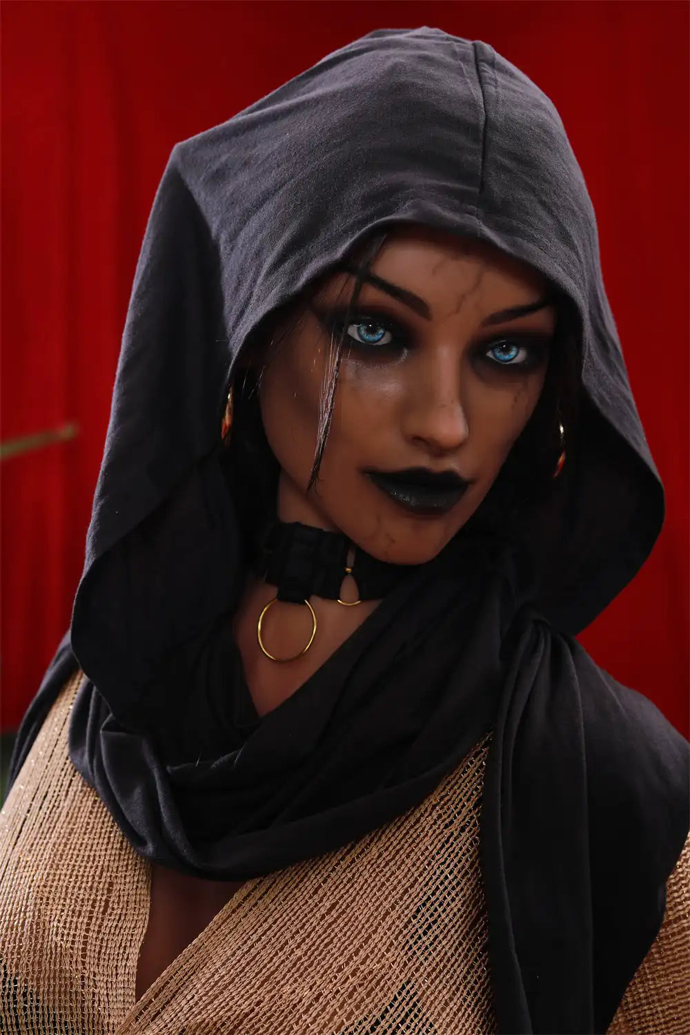 Close-up of Vhaera elf sex doll's face framed by a dark hood