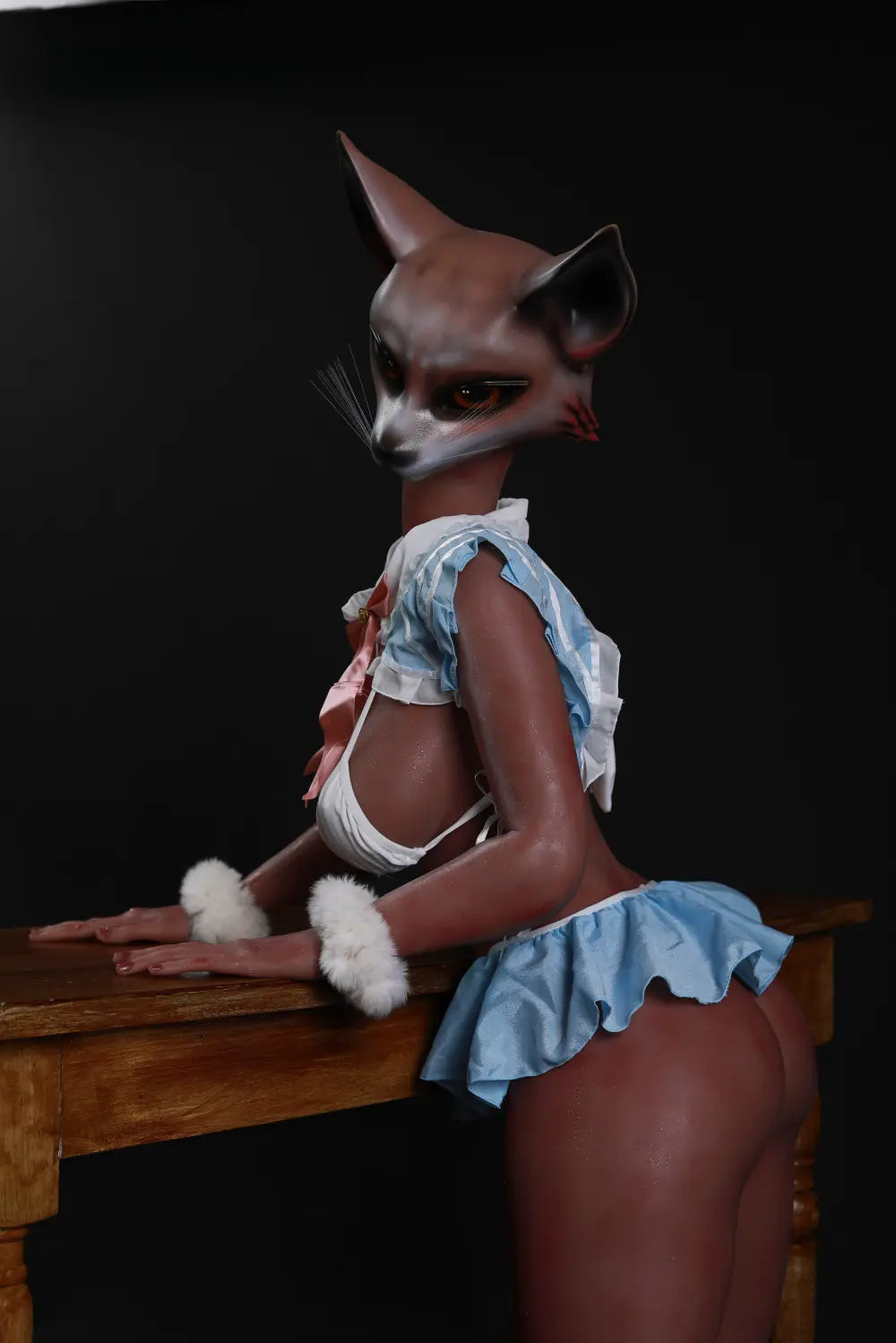 Side portrait of Vesper fox sex doll with pointed ears, blue costume ruffles and white wrist cuffs