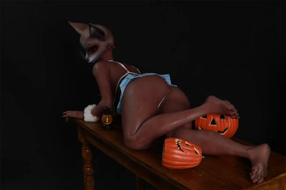 Wide rear three-quarter view of Vesper fox sex doll on a wooden table with pumpkin props