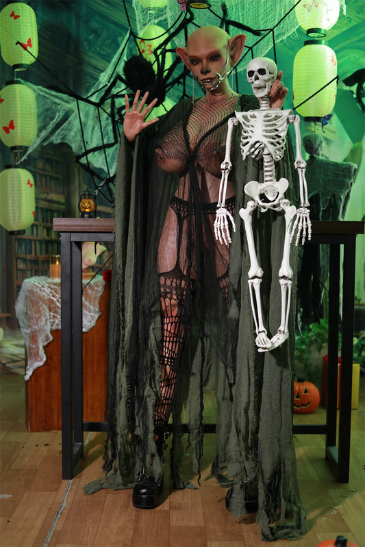 Nethrava alien necromancer sex doll in a netted outfit beside a skeleton prop in a green-lit setting