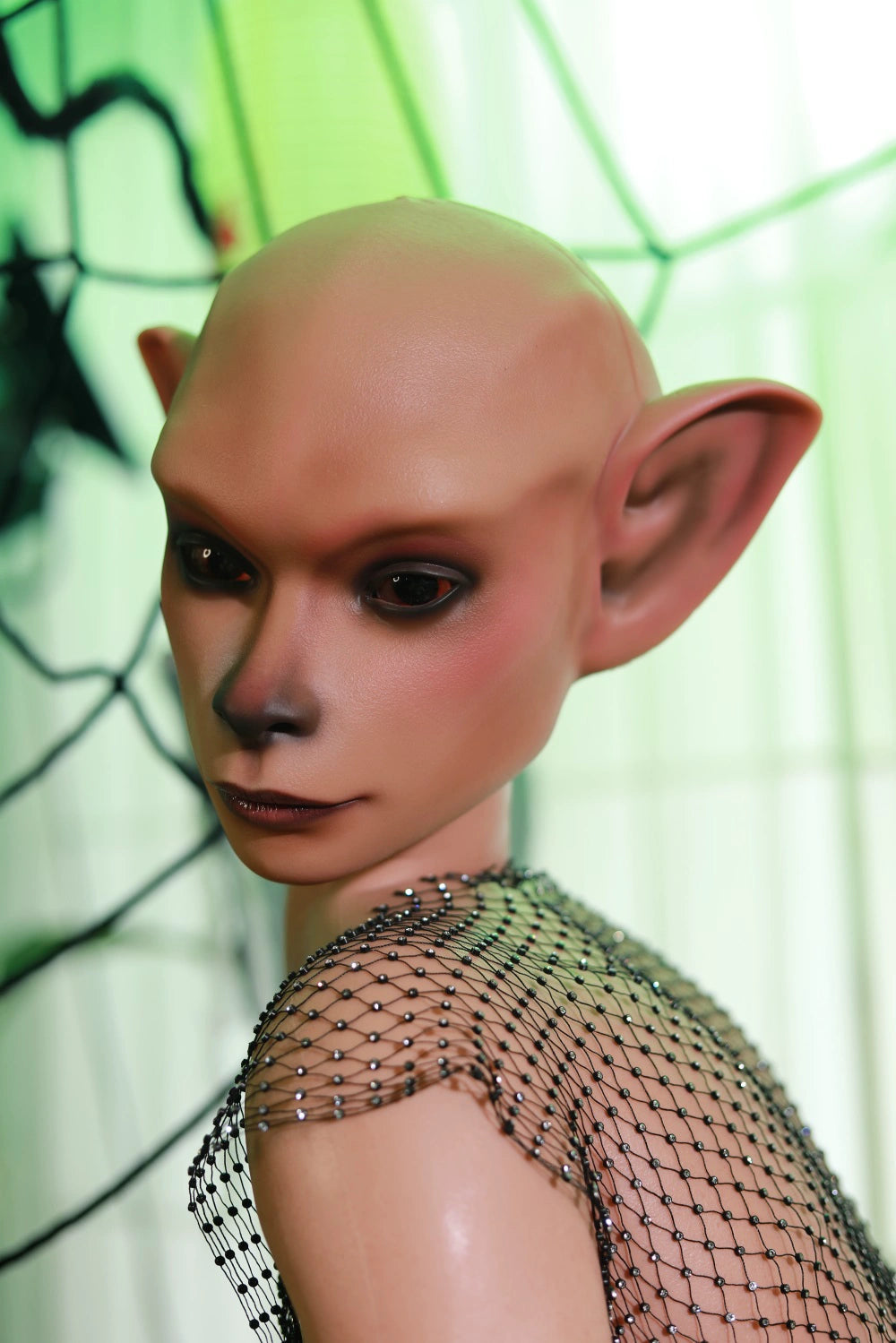 Close-up of Nethrava sex doll's face showing the dark nose and large pointed ears