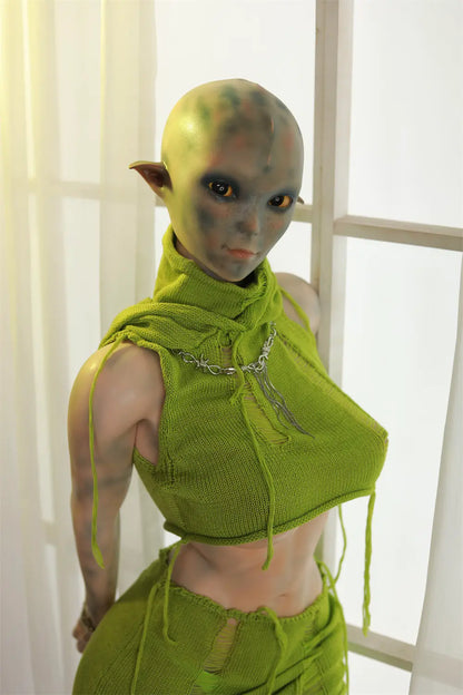 Rear three-quarter view of Sylvara sex doll showing the green hood and costume straps