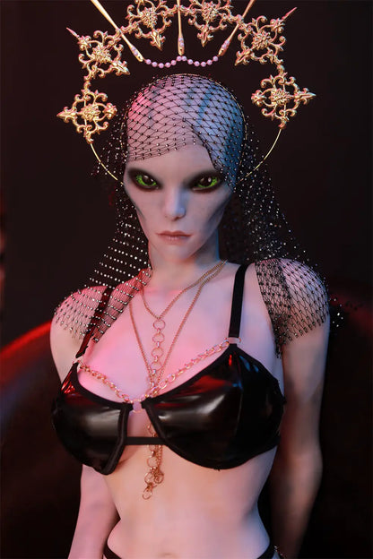 Full-length front view of Aelyth sex doll seated with legs apart in a black strappy outfit