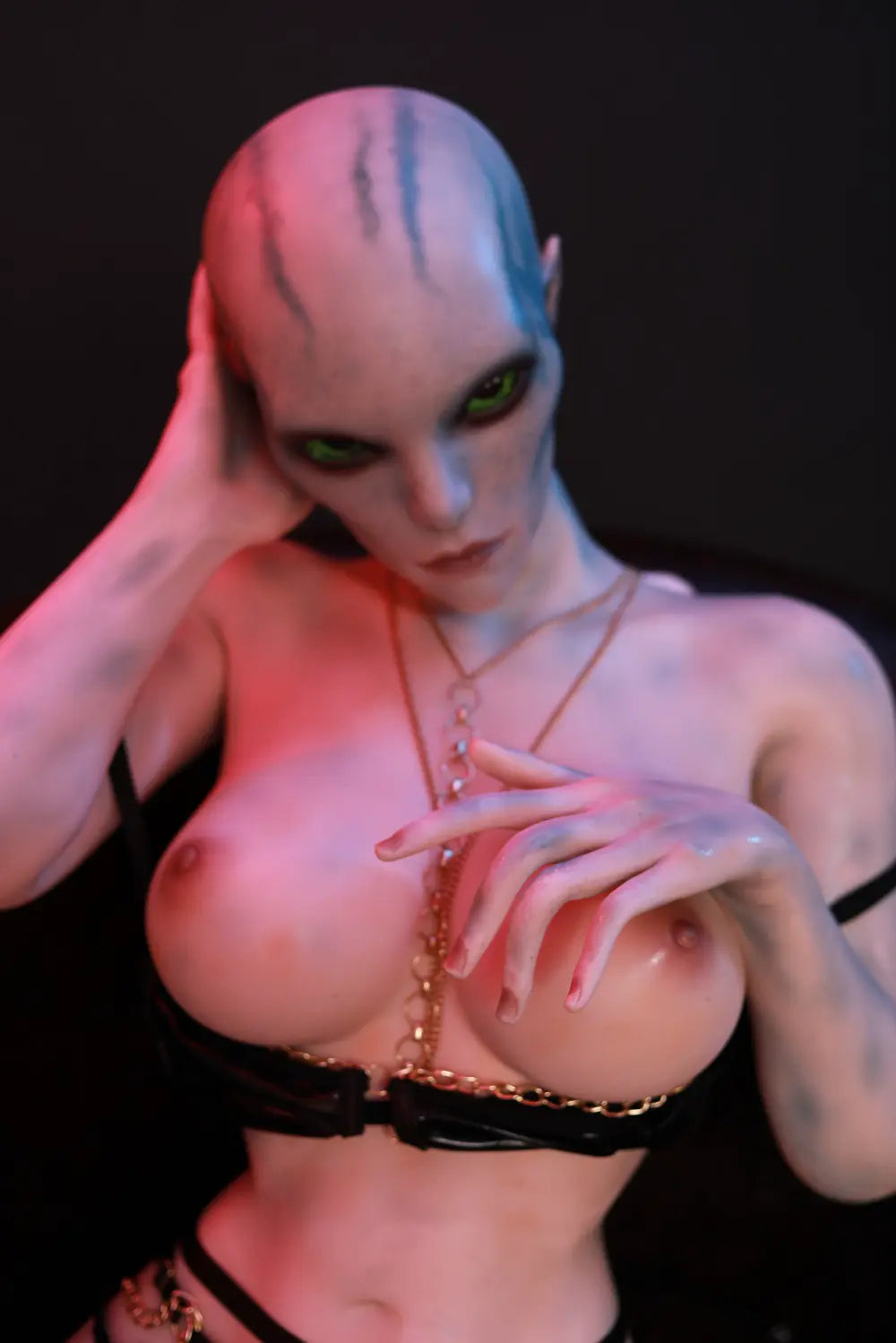 Full-length view of Aelyth sex doll seated with legs apart and hands raised near the shoulders
