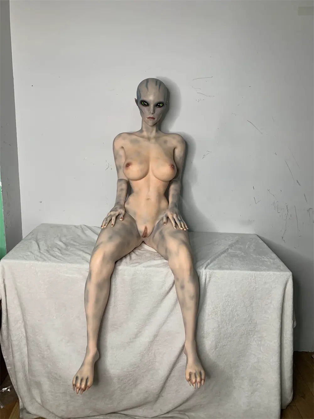 Closer rear view of Aelyth sex doll showing pale blue markings across the back and hips