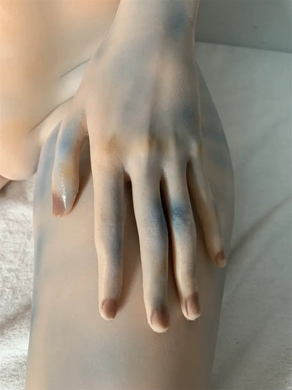 Factory close-up of Aelyth's alien face showing dark eye surrounds and pale blue head markings