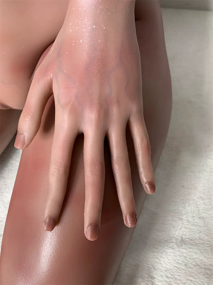 Factory detail photo of Zivra sex doll's hand resting on the thigh, showing sculpted fingers and nails