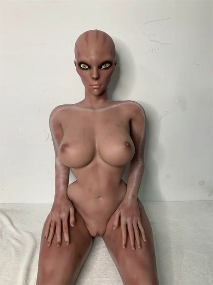 Front factory reference view of Nyxie sex doll showing the alien head, torso and hands on the thighs
