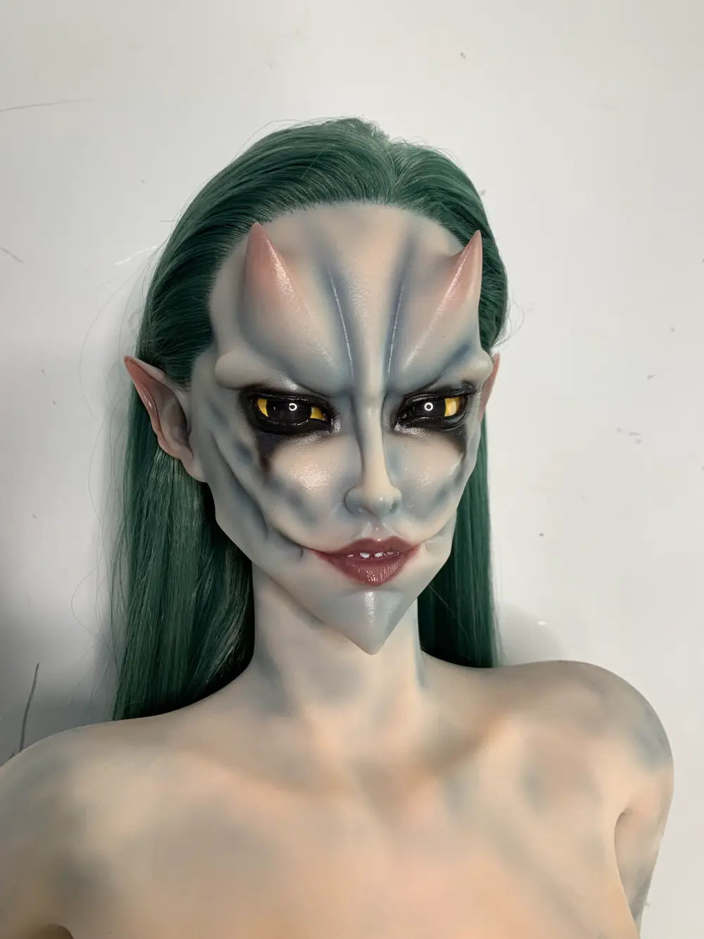 Factory close-up of Morveth's fantasy face with dark markings and green hair