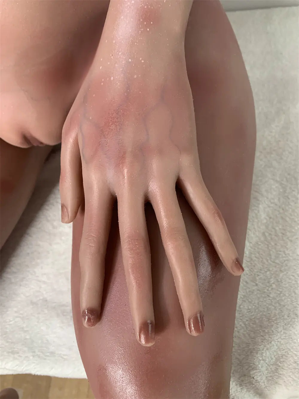 Factory close-up of Tauris sex doll's face showing curved horns, eye details and sculptural ears