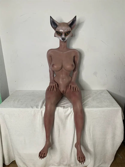 Factory reference photo of unclothed Vesper fox sex doll seated on a white-covered platform