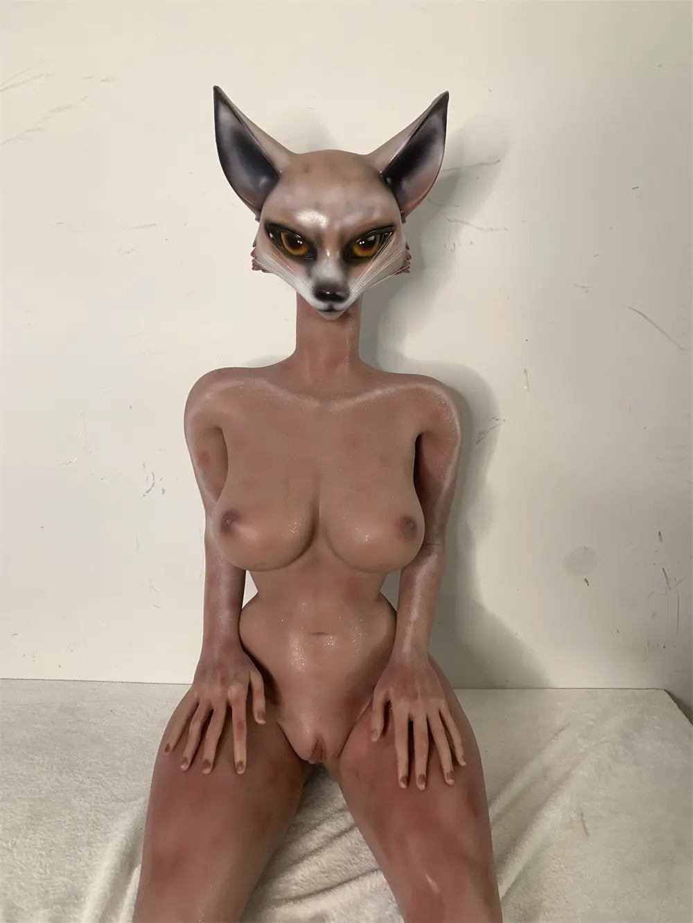 Front factory reference view of Vesper fox sex doll seated with hands resting on the thighs