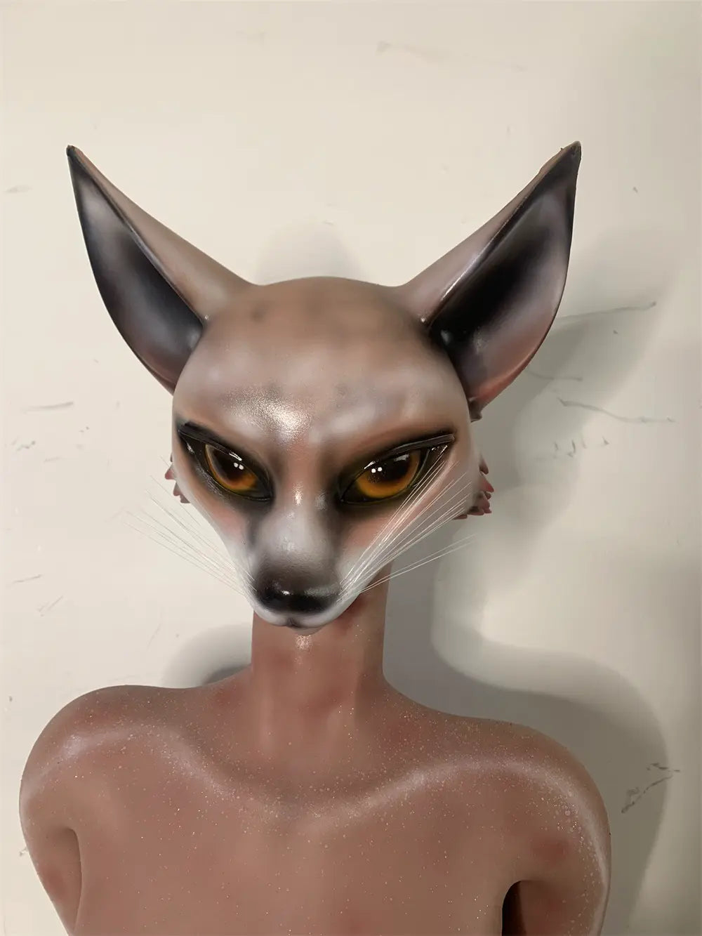Factory close-up of Vesper fox face showing amber-colored eyes, pointed ears and fine whiskers