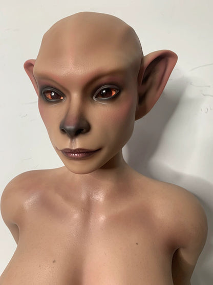 Factory close-up of Nethrava sex doll's hairless head, dark nose and pointed ears